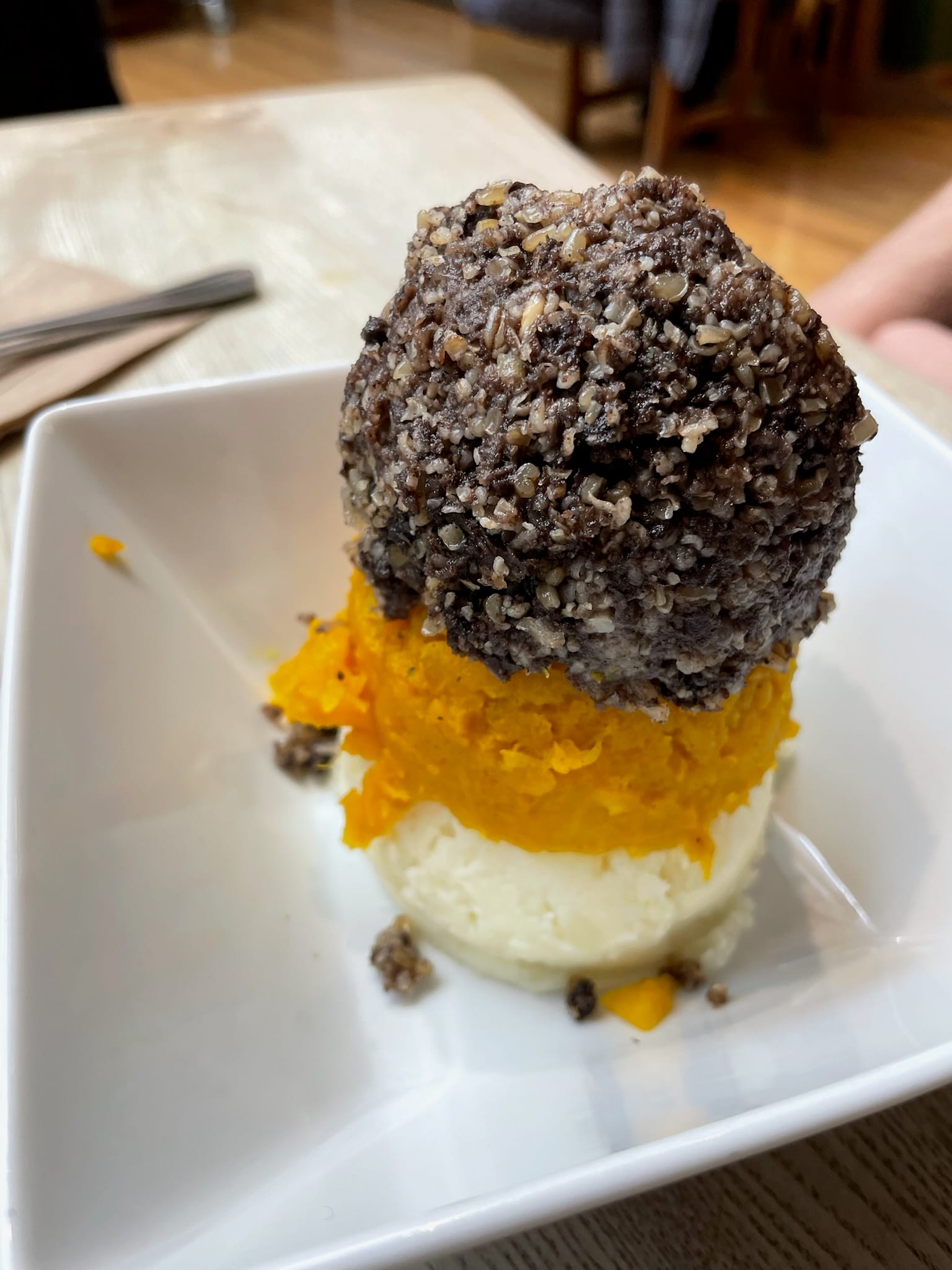 A close-up photo of haggis, neeps, and tatties, ordered at "The Haggis Box" cafe within the Scottish Storytelling Centre.