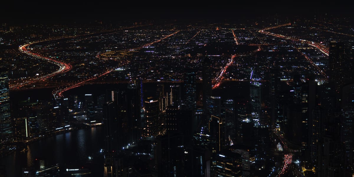 A nighttime view of Dubai from the 124th floor of the Burj Khalifa, showcasing the insane traffic levels across the city.