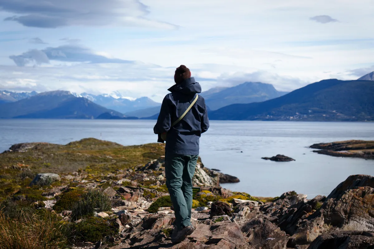 Rachel standing on top of an island nearby Ushuia, Argentina, looking out over the inlet.
