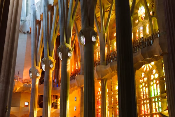 The west windows of the Sagrada Família, lit up in the afternoon, viewed from the interior.